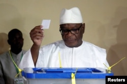FILE - Ibrahim Boubacar Keita, President of Mali and candidate for Rally for Mali party (RPM), casts his vote at a polling station during a runoff presidential election in Bamako, Aug. 12, 2018.