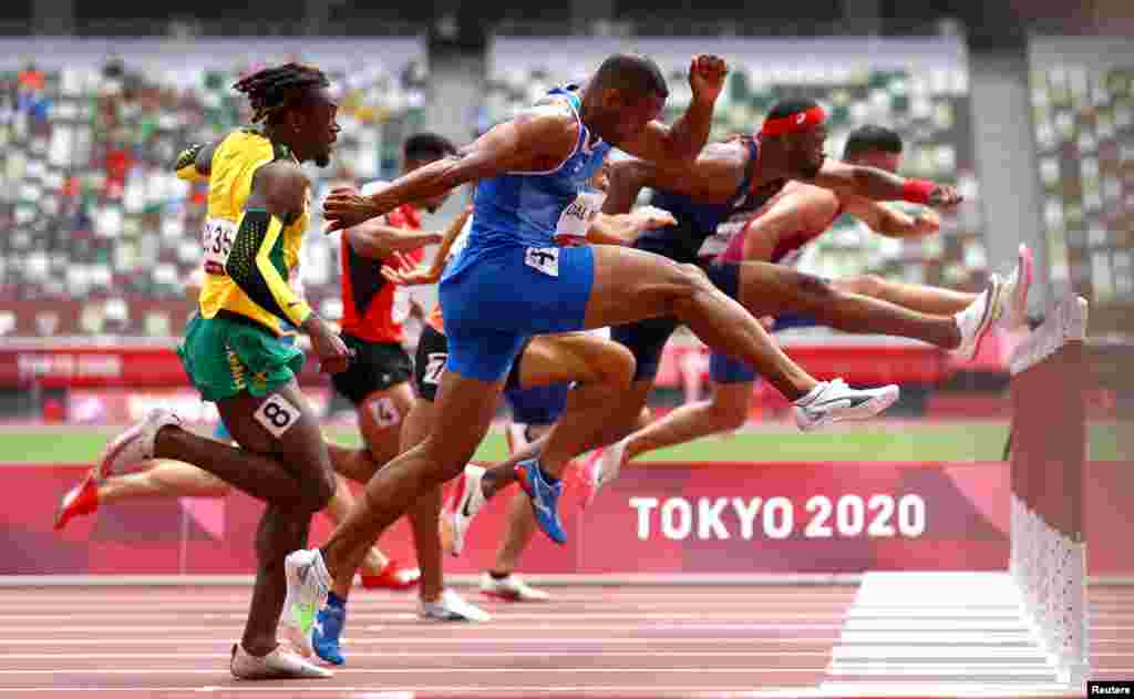Athletes compete in the men&#39;s 110-meter hurdles at the 2020 Summer Olympics in Tokyo, Japan.