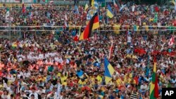 Pilgrims and faithful attend the opening Mass for the World Youth Day in Krakow, Poland, Tuesday, July 26, 2016.