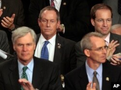 FILE - Rep. Joe Wilson, R-S.C., center, listens during President Barack Obama's speech on health care to a joint session of Congress on Capitol Hill in Washington, Sept. 9, 2009. During the address, Wilson shouted, "You lie!"