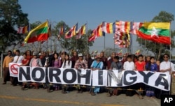 Myanmar protesters hold banners outside Thilawa port where a Malaysian ship full of aid for the Muslim Rohingya minority arrived, in Yangon, Myanmar, Feb. 9, 2017. The protesters deny that the ethnic group Rohingya even exists.