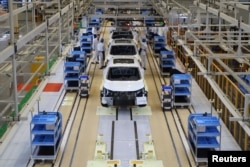FILE - Workers are seen on the production line at Honda Motor's new joint venture plant with Dongfeng Motor Group in Wuhan, Hubei province, China April 12, 2019. (REUTERS/Norihiko Shirouzu)