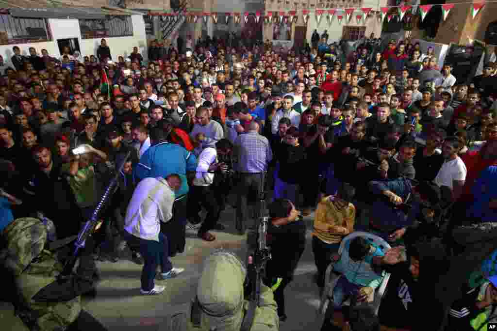 Palestinian militants fire during a celebration after the release of Palestinian prisoner Mohammed Sabbagh in the West Bank refugee camp of Jenin, Oct. 30, 2013.