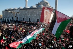Thousands of protesters, some holding Palestinian and Turkish flags march in the streets after Friday prayers in Istanbul, Dec. 8, 2017, against U S. President Donald Trump's decision to recognize Jerusalem at the capital of Israel.