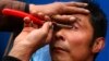 Chinese Barber, Clients Swear by Eyelid Shave