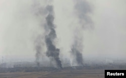 Smoke rises from clashes at Bartila in the east of Mosul during clashes with Islamic State militants, Iraq, Oct. 18, 2016.