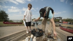 Volunteers participating in the International Coastal Cleanup collect litter in the Anacostia area of Washington, DC.