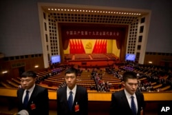 Security personnel stand guard after the opening session of China's 19th Party Congress at the Great Hall of the People in Beijing, Oct. 18, 2017.