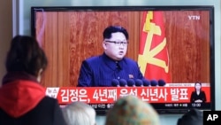 South Koreans watch a TV news program showing North Korean leader Kim Jong Un's New Year speech, at the Seoul Railway Station in Seoul, South Korea, Friday, Jan. 1, 2016.