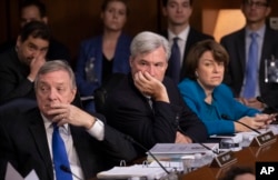 Democrats on the Senate Judiciary Committee, from left, Sen. Dick Durbin, D-Ill., Sen. Sheldon Whitehouse, D-R.I., and Sen. Amy Klobuchar, D-Minn., and other minority members, appeal to Chairman Chuck Grassley, R-Iowa, to delay the confirmation hearing of President Donald Trump's Supreme Court nominee, Brett Kavanaugh, on Capitol Hill in Washington, Sept. 4, 2018.