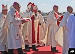 Bishop Juan Barros (2nd-R) arrives to attend a Mass celebrated by Pope Francis at the Maquehue Air Base in Temuco, Chile, Jan. 17, 2018.