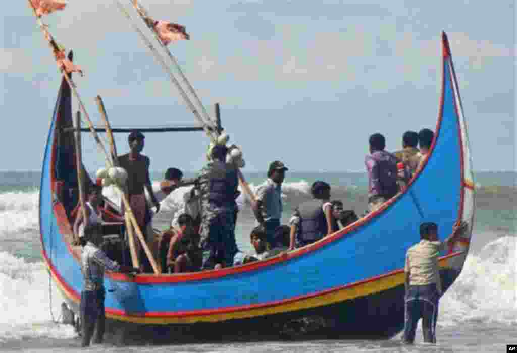 Bangladesh Border Guard soldiers check survivors rescued from a boat capsize in Teknaf, Bangladesh, Wednesday, Nov. 7, 2012. Officials said Wednesday that 23 people were rescued after an overcrowded boat capsized off the Bangladesh coast, but about 50 oth