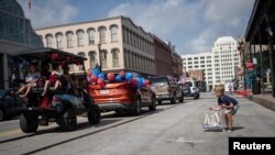 Jack Nolingberg, 6 tahun, memungut permen-permen yang dilemparkan dari parade Hari Kemerdekaan AS di Texas, 4 Juli 2020. (Foto: Reuters)