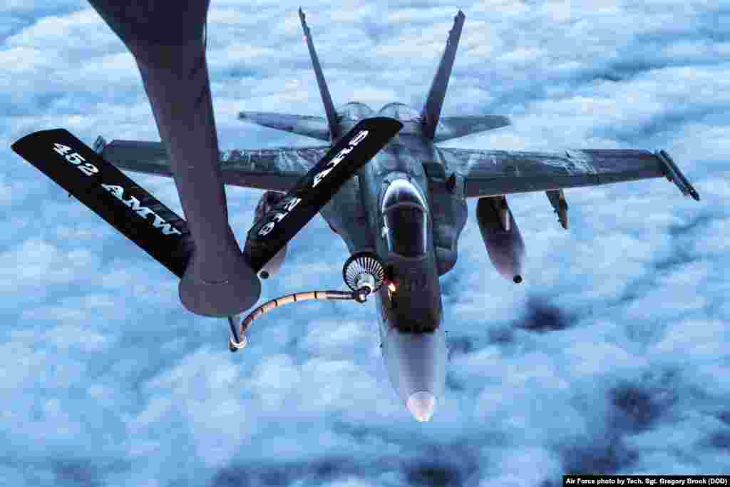 An Air Force KC-135 Stratotanker refuels a Canadian Air Force CF-18s over Alaska during Vigilant Shield 2017, a training exercise in the high Arctic.