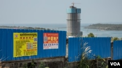 New commercial advertisements are seen posted on a newly-built building in Sihanoukville province, Cambodia, February 13, 2019. (Khan Sokummono/VOA Khmer)