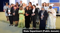 U.S. Secretary of State John Kerry and U.S. Ambassador-at-Large for Global Women's Issues Cathy Russell pose for a photo with the 2016 Secretary of State’s International Women of Courage Award winners at the U.S. Department of State in Washington, D.C., o