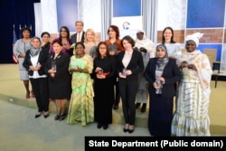 U.S. Secretary of State John Kerry and U.S. Ambassador-at-Large for Global Women's Issues Cathy Russell pose for a photo with the 2016 Secretary of State’s International Women of Courage Award winners at the U.S. Department of State in Washington, D.C., on March 29, 2016.