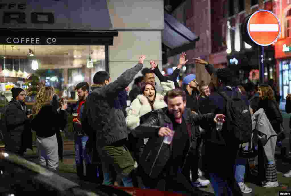 A group of people dance as they party on a street in Soho, as the coronavirus disease (COVID-19) restrictions ease in London, April 12, 2021.