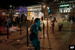 People run after police fired tear gas following clashes after the Euro 2016 soccer championship group B match between England and Russia in Marseille, France on June 11, 2016.