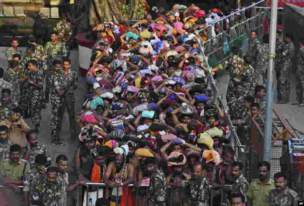 Devotees wait to worship at the Sabarimala temple, one of the world&#39;s largest Hindu pilgrimage sites, Kerala state, India. The historic temple which had barred women age 10 to 50 from entering the temple, opened to Hindu pilgrims for a day.