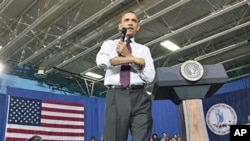 President Barack Obama rolls up his sleeves during a town hall meeting to discuss reducing the national debt at Northern Virginia Community College in Annandale, Va., April 19, 2011