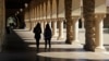 FILE- Students walk on the Stanford University campus in Santa Clara, California, March 14, 2019. 