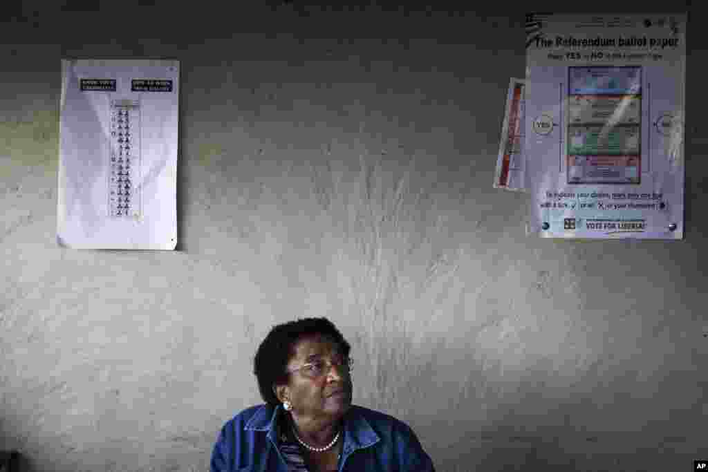 Nobel Peace Prize Laureate and incumbent leader Ellen Johnson-Sirleaf sits at a resident's home after voting during presidential elections at her home village of Fefee outside the capital Monrovia November 8, 2011. Rising tension, a planned opposition boy