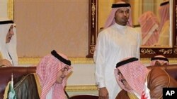 Saudi FM Prince Saudi al-Faisal, left, speaks with Bahrain's FM Sheikh Khaled bin Ahmad al-Khalifa, left, before the foreign ministers of the Gulf Cooperation Council 'GCC', in Riyadh, Saudi Arabia, May 1, 2011