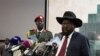 South Sudanese President Salva Kiir (R), shown delivering a speech to lawmakers, has retracted a statement that was widely perceived as a threat against journalists. 