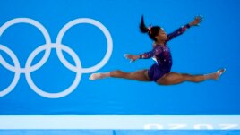 FILE- Simone Biles, of United States, performs her floor exercise routine during the women's artistic gymnastic qualifications at the 2020 Summer Olympics, Sunday, July 25, 2021, in Tokyo. (AP Photo/Ashley Landis)