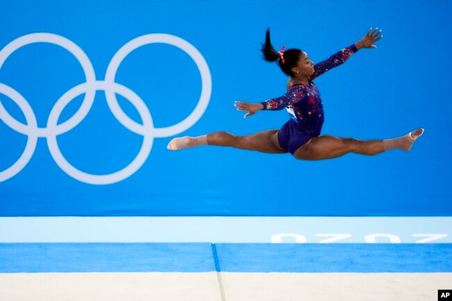 FILE- Simone Biles, of United States, performs her floor exercise routine during the women's artistic gymnastic qualifications at the 2020 Summer Olympics, Sunday, July 25, 2021, in Tokyo. (AP Photo/Ashley Landis)