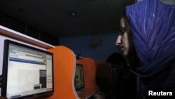 An Afghan woman browses the YouTube website at a public internet cafe in Kabul. Like Afghanistan, Indonesia seeks to ban the YouTube website showing a U.S.-made film insulting the Prophet Mohammad, Sept. 12, 2012.