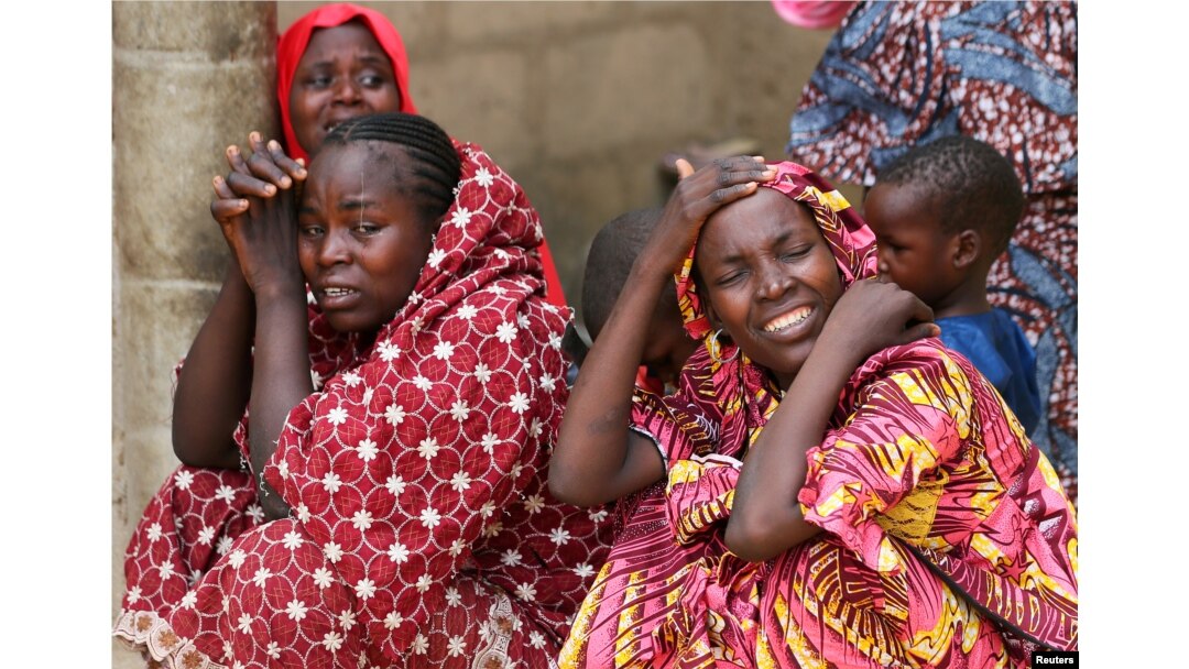 FILE - Relatives of missing school girls react in Dapchi in the northeastern state of Yobe, after an attack on the village by Boko Haram, Nigeria, Feb. 23, 2018.