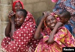 FILE - Relatives of missing school girls react in Dapchi in the northeastern state of Yobe, after an attack on the village by Boko Haram, Nigeria, Feb. 23, 2018.