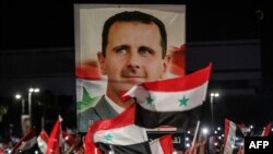 ARHIVA - Slavlje na ulicama Damaska u danima pošto je Bašar al Asad proglasio pobedu na izborima čije rezultate ne priznaje veći deo međunadorne zajednice predvođen zemljama Zapada (Foto: AFP/Louai Beshara)