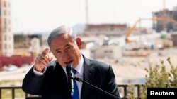 FILE - Israeli Prime Minister Benjamin Netanyahu delivers a statement in front of new construction, in the Jewish settlement known to Israelis as Har Homa and to Palestinians as Jabal Abu Ghneim, in an area of the West Bank that Israel captured in a 1967 war and annexed to the city of Jerusalem, March 16, 2015.