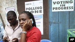 An election officer in Nigeria's commercial capital, Lagos, makes a phone call after the postponement of parliamentary elections, April 2, 2011