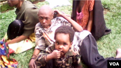 A captured jihadist ADF combatant and child. (Yassin Kombi/VOA)