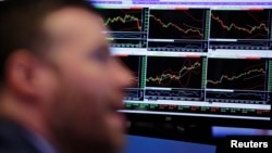 A trader works on the floor of the New York Stock Exchange (NYSE) shortly after the opening bell in New York, U.S., March 22, 2017.