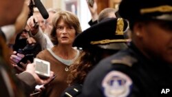 Sen. Lisa Murkowski, R-Alaska, is surrounded by reporters asking questions about Supreme Court nominee Brett Kavanaugh, Friday Sept. 28, 2018, on Capitol Hill in Washington.