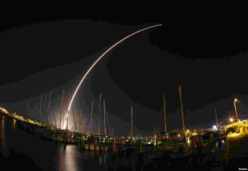 A view of the Delta IV rocket streaking across the sky after launching from Cape Canaveral Air Force Station is seen from Port Canaveral, Florida, Feb. 20, 2014. 