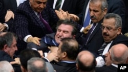 Legislators from Prime Minister Erdogan's ruling party and main opposition Republican People's Party brawl during tense all-night debate, Ankara, Feb. 15, 2014.