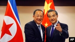 N. Korean Foreign Minister Ri Yong Ho, left, is greeted by his Chinese counterpart Wang Yi prior to their bilateral meeting on the sidelines of the 50th ASEAN Foreign Ministers' Meeting and its Dialogue Partners, Aug. 6, 2017. 