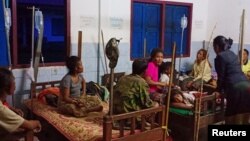 Villagers are seen inside a temporary shelter as they evacuate after a hydropower dam collapsed in Attapeu province, Laos, July 24, 2018.