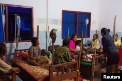 FILE - Villagers are seen inside a temporary shelter as they evacuate after a hydropower dam collapsed in Attapeu province, Laos, July 24, 2018.