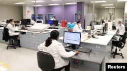 Chemists work at AstraZeneca's headquarters, after Prime Minister Scott Morrison announced Australians will be among the first in the world to receive a coronavirus disease (COVID-19) vaccine, if it proves successful, through an agreement between the gove