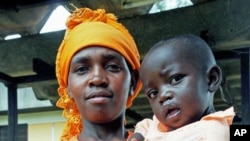 A Rwandan woman holds her child, who is recovering from a cleft-palate surgery performed during a mission by South Africa based Operation Smile, in Kigali, Rwanda, March 22, 2012.