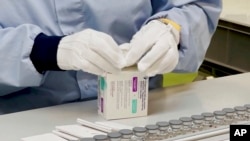 In this image from undated video provided by AstraZeneca in December 2021, a worker packages the company's Evusheld medication. 