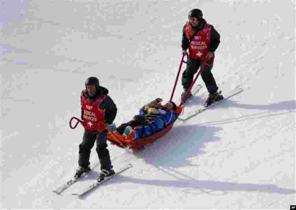 Jacqueline Hernandez of the United States is carried off the course in a stretcher after crashing in a seeding run during women's snowboard cross competition at the Rosa Khutor Extreme Park, at the 2014 Winter Olympics, Sunday, Feb. 16, 2014, in Krasnaya 