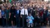 President Barack Obama, center, walks as he holds hands with Amelia Boynton Robinson, who was beaten during "Bloody Sunday," as they and the first family and others including Rep. John Lewis, D-Ga,, left of Obama, walk across the Edmund Pettus Bridge in S